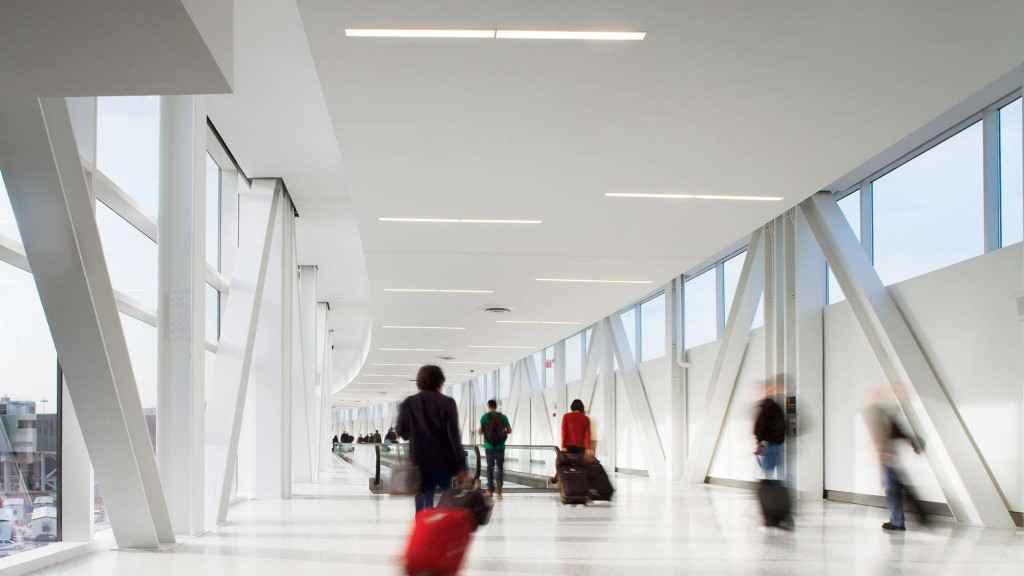 People with luggage in a building.