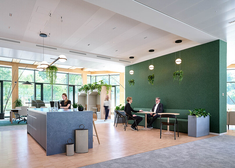 Synopsys Munich workplace with green wall and counter