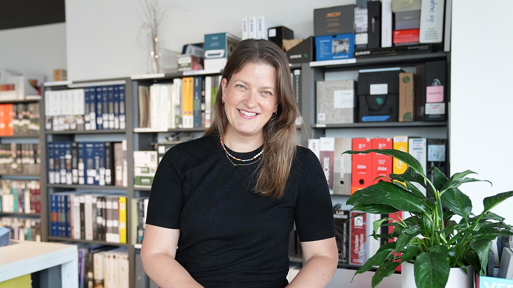 A person smiling in a room.