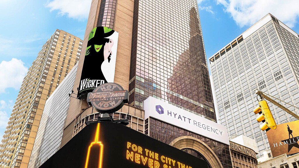 A street sign in front of a large building.