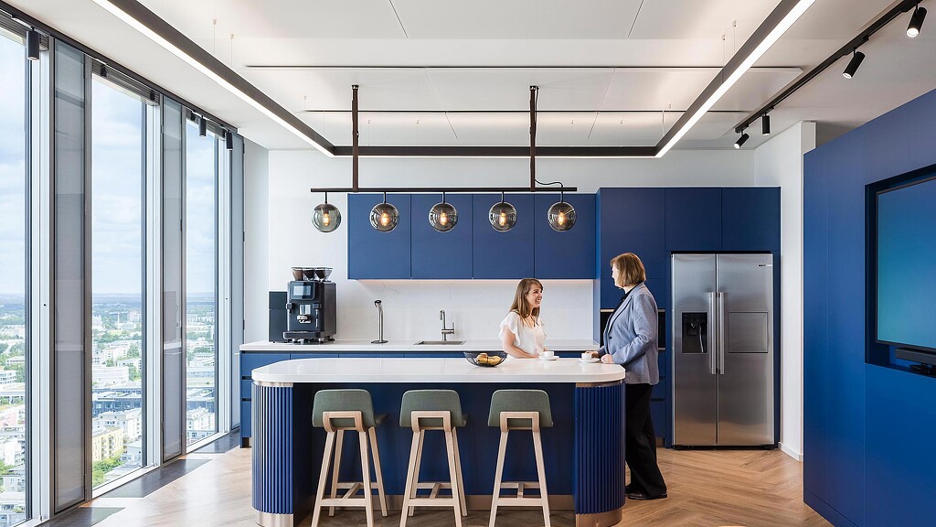A man and woman standing in a kitchen.