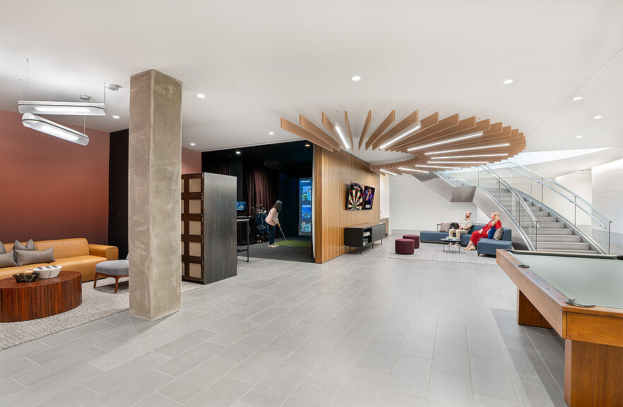 A large room with a few people.