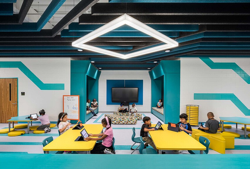 A group of people sitting at tables.