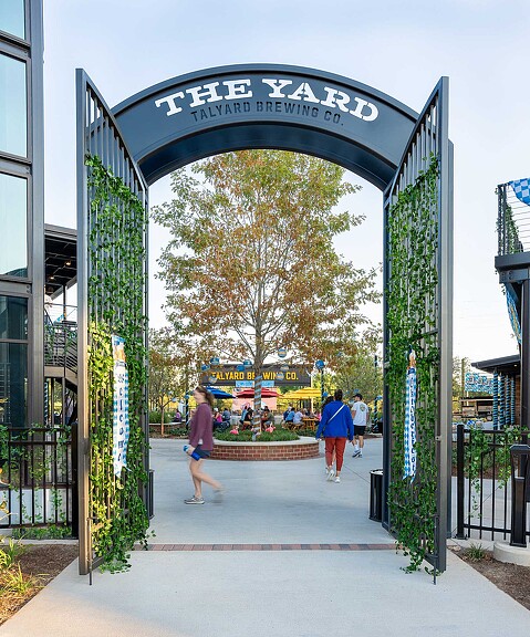 People walking under a sign.