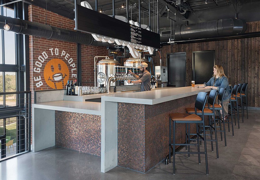 A couple of people sitting at a bar.