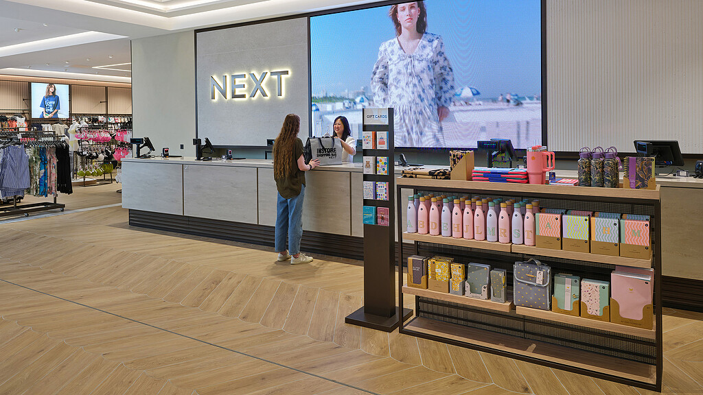 A person standing in front of a display of products.