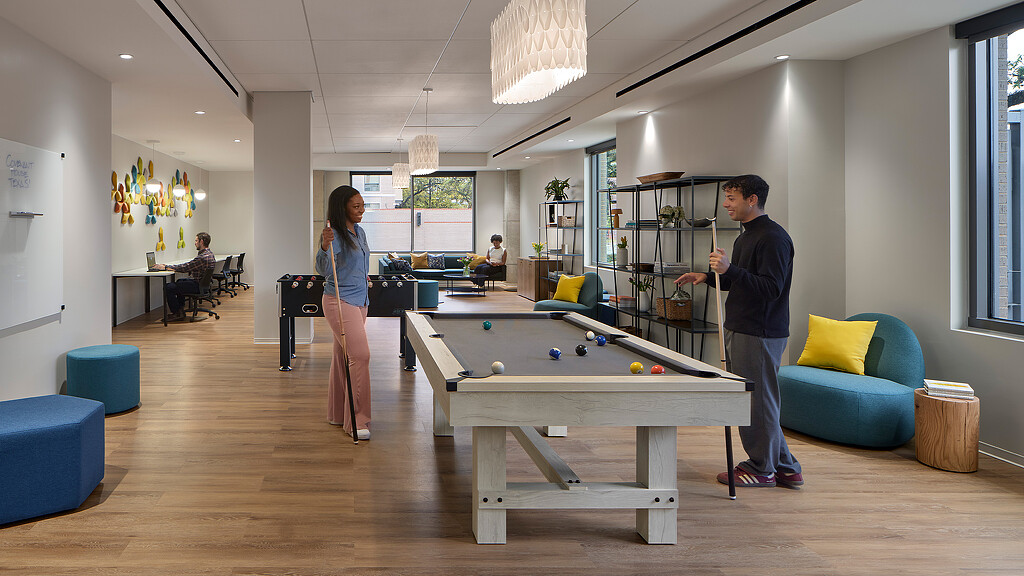 A man and a woman playing pool.