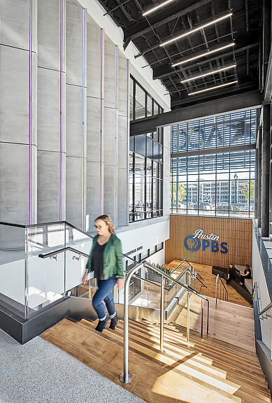 A person standing on a metal railing.