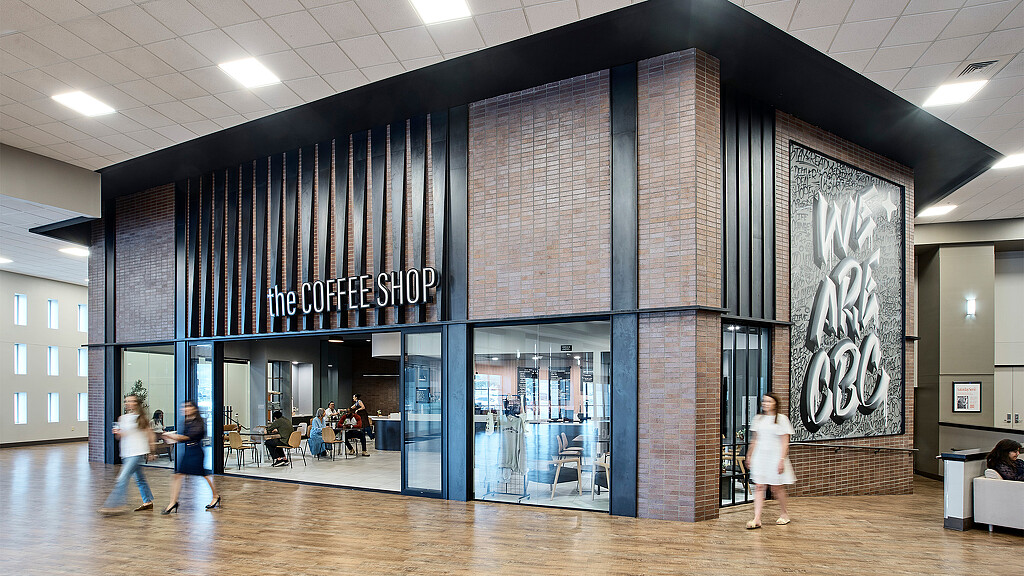 A group of people walking in a building.