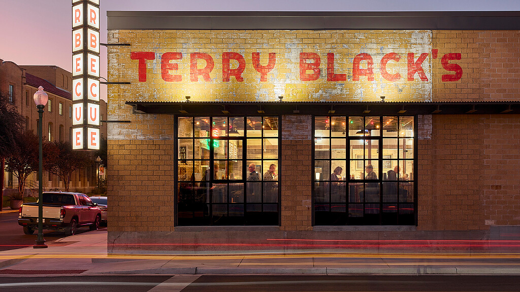 A store front with a red sign.
