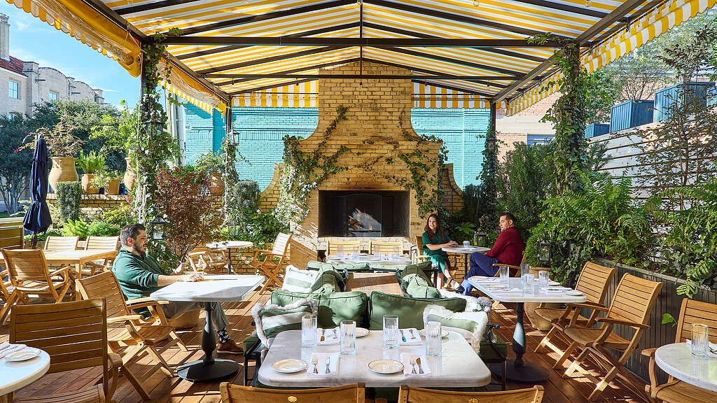 People sitting at tables outside.