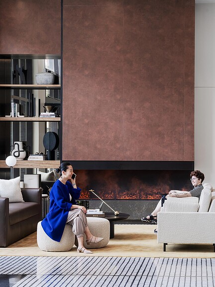 A person sitting on a couch talking on a cell phone.