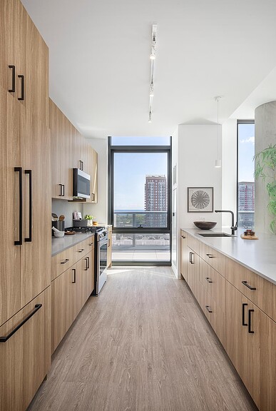 A kitchen with wooden cabinets.