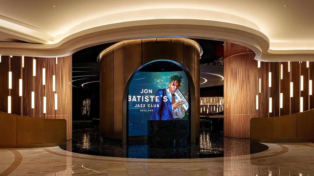 A person on a screen in a building.