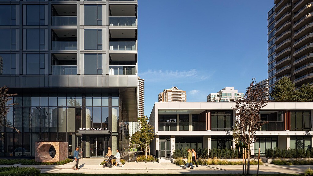 A group of people walking around a building.