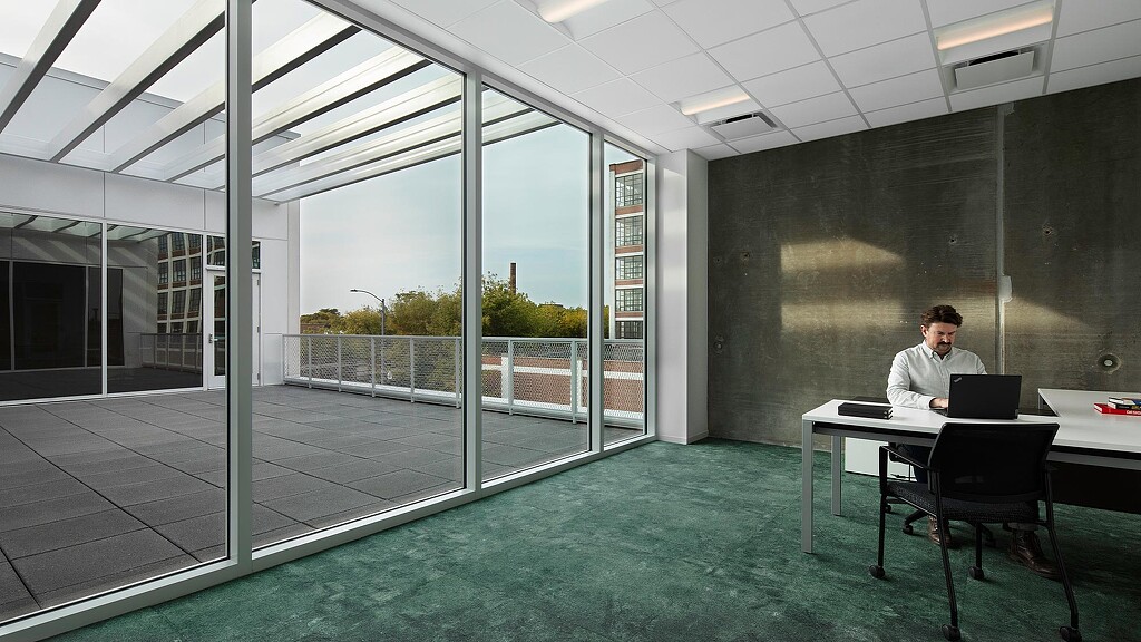 A person sitting at a desk with a laptop.