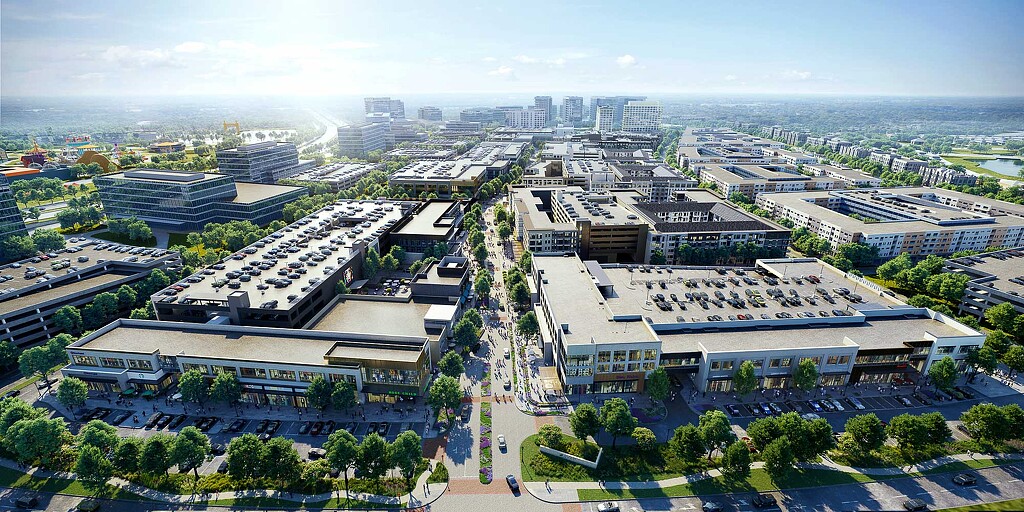 A large building with a courtyard and trees in front of it.