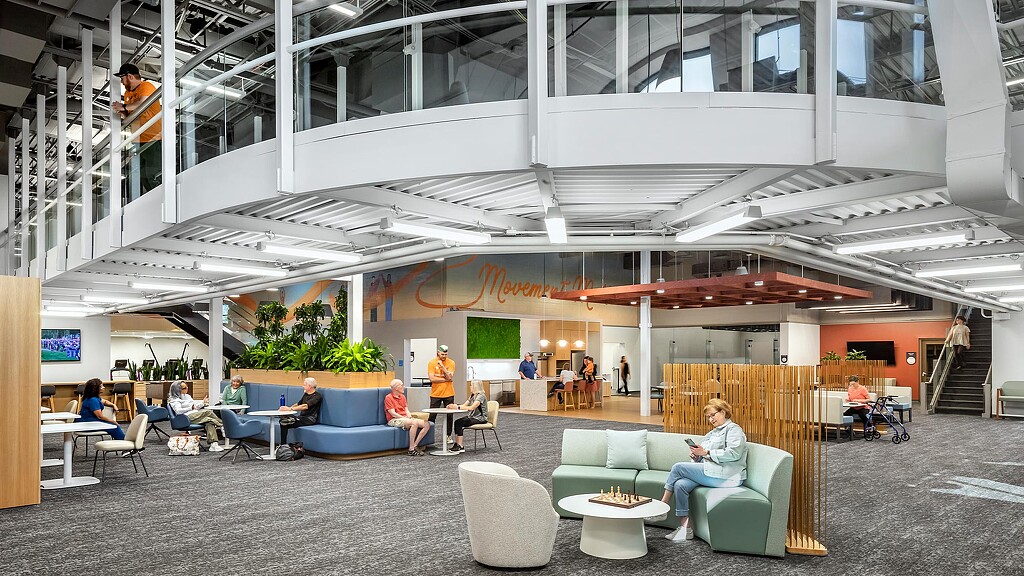 People sitting in chairs in a building.
