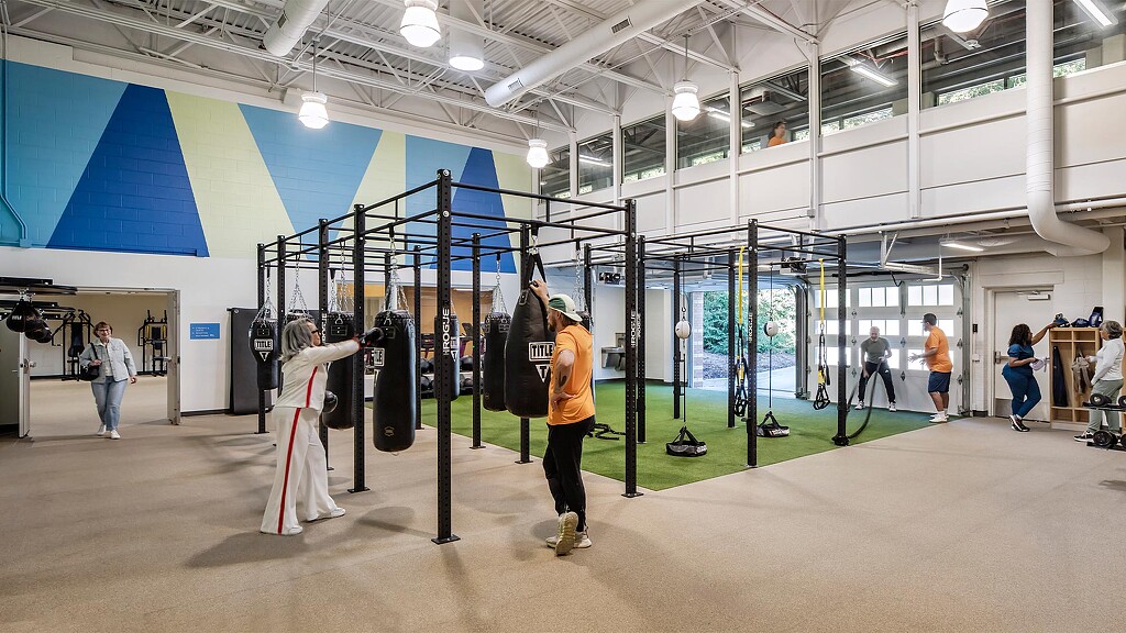 People with luggage in a large room.