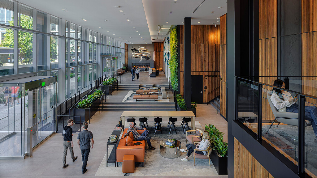 A group of people walking through a building.