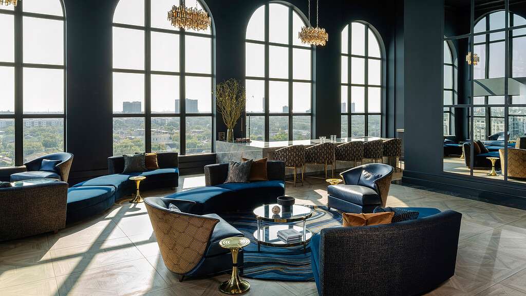 A room with a large window and chairs.