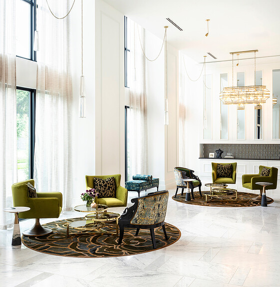 A room with chairs and a chandelier.