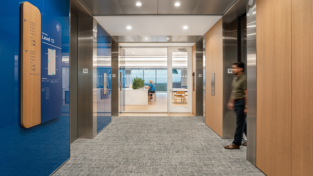 A person standing in a hallway.