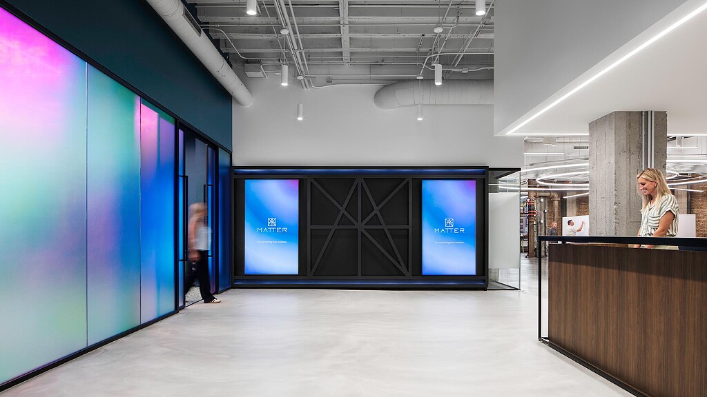 A person standing next to a display.