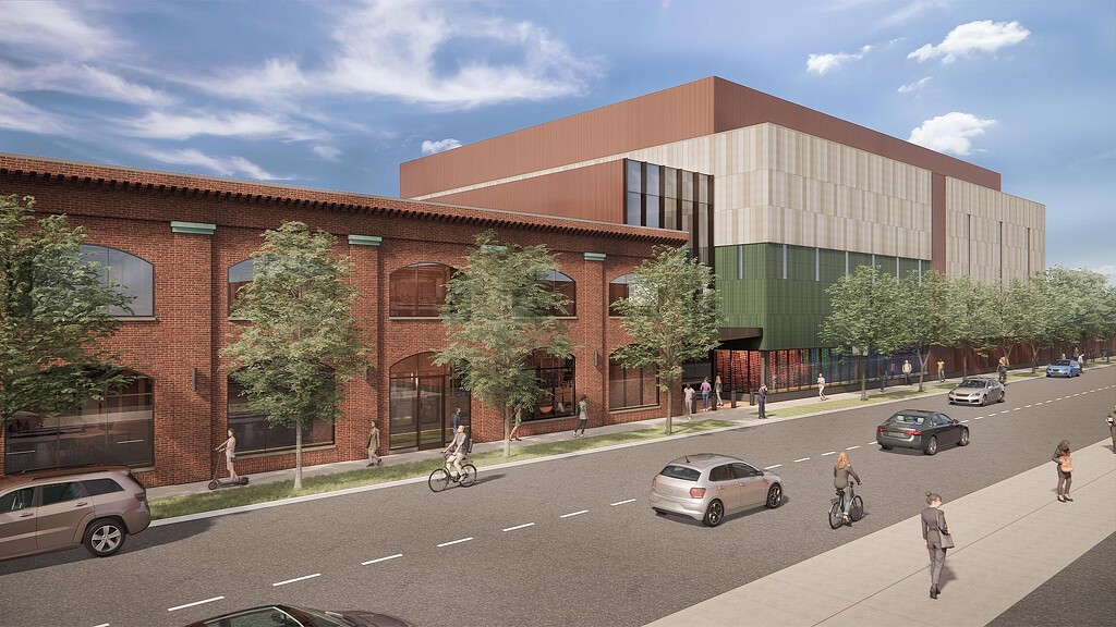 A building with a street and cars.