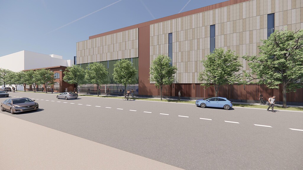 A street with cars and a building.