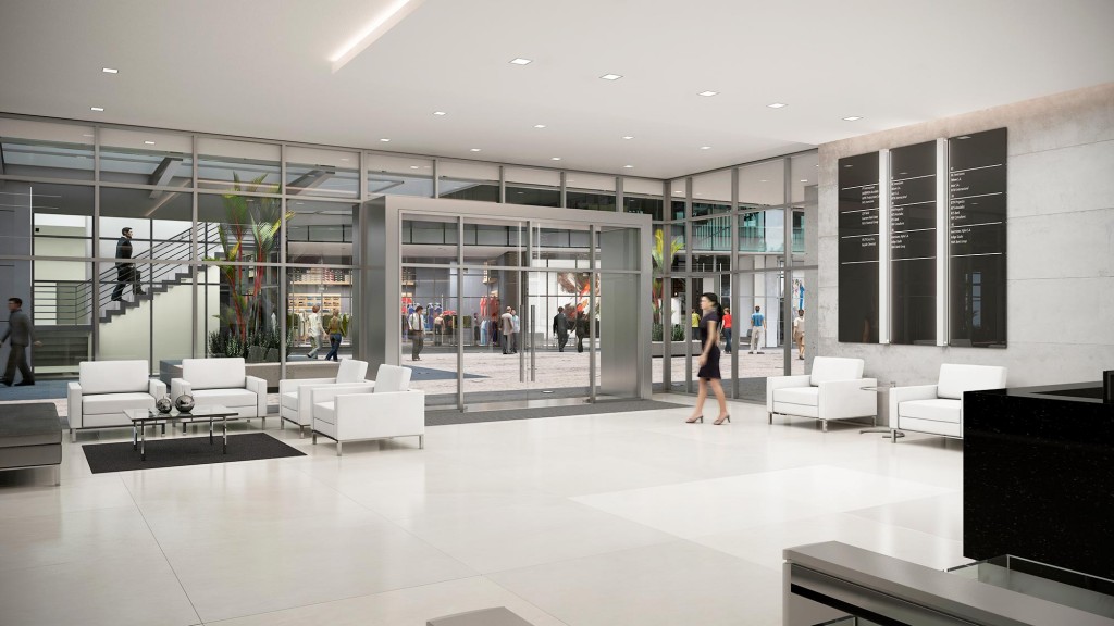 A large room with white couches and people in it.