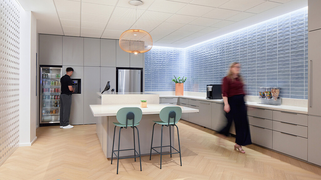 A man and woman in a kitchen.