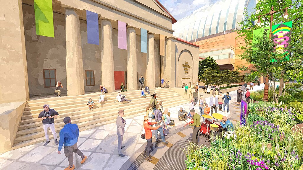 A group of people walking around a courtyard with flowers and a building.