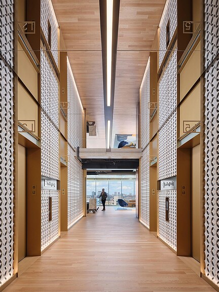 A long hallway with a person walking.