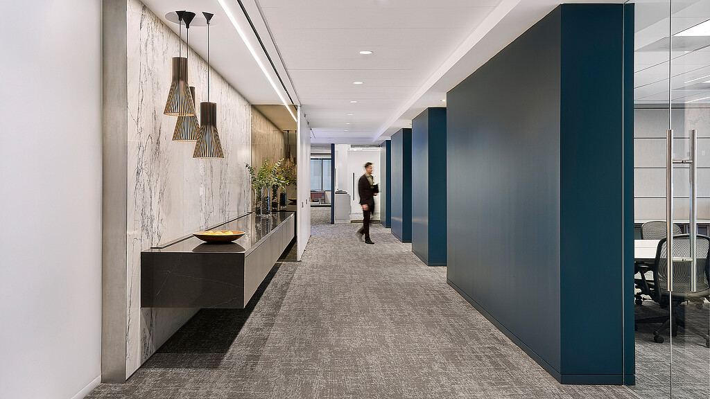 A person walking down a hall.