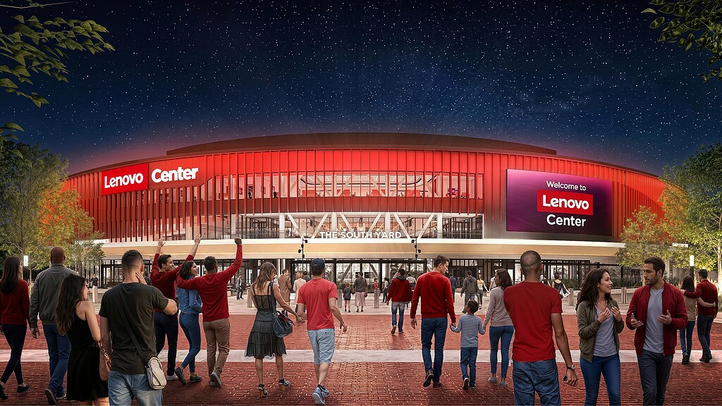 A group of people walking in front of a building with a red roof.