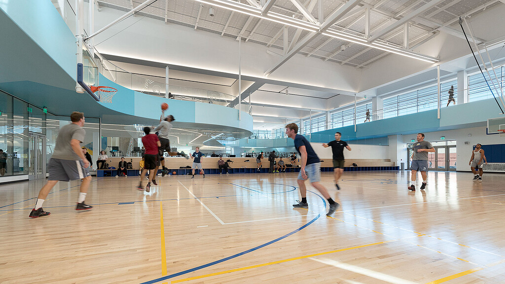 A group of people playing basketball.