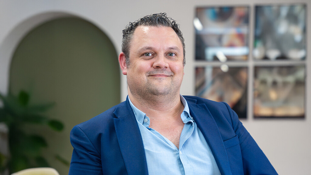 A man in a blue shirt.