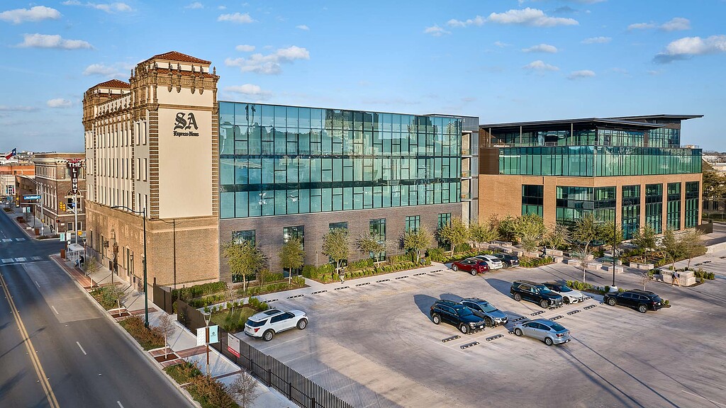 A large building with a parking lot.