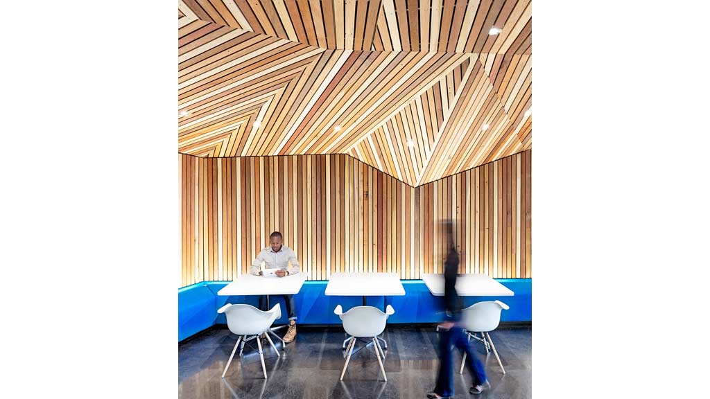 A man and woman sitting at a table with white tables and chairs.
