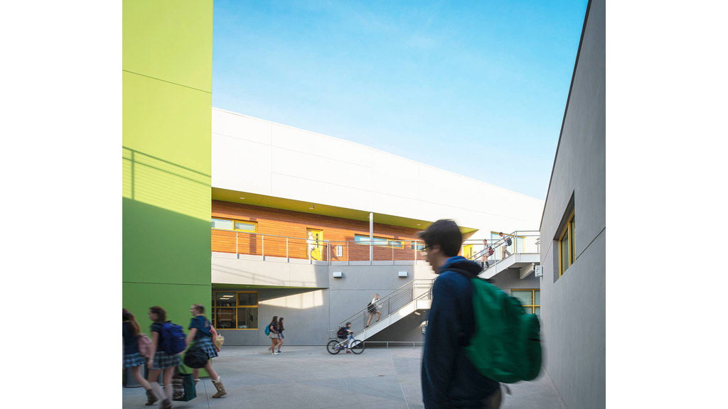 A group of people walking outside a building.