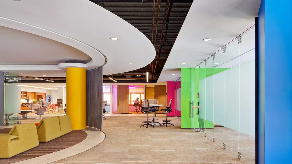 A long hallway with a table and chairs.