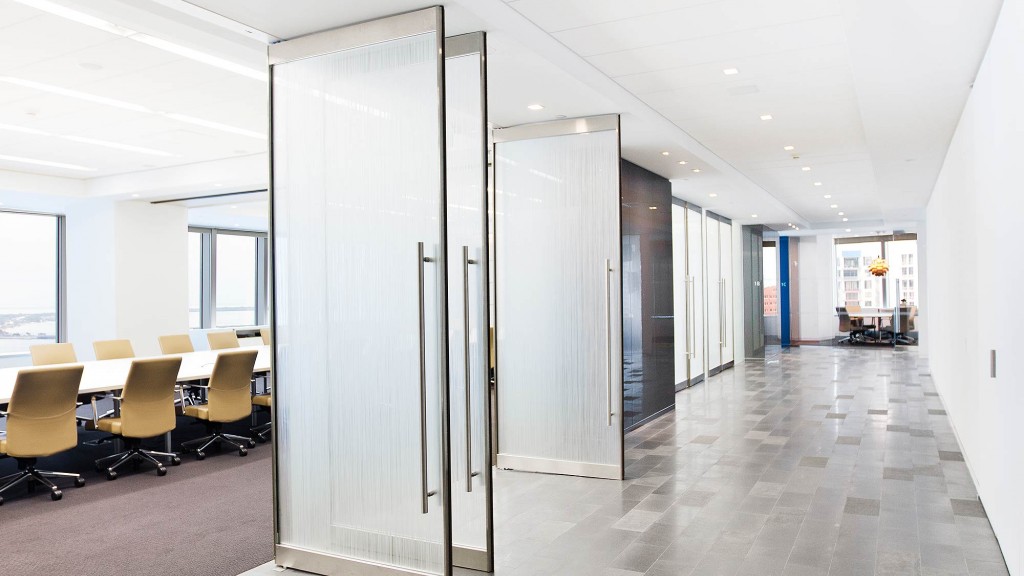 A long hallway with chairs and a table.