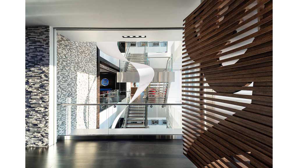 A room with a staircase and a glass door.