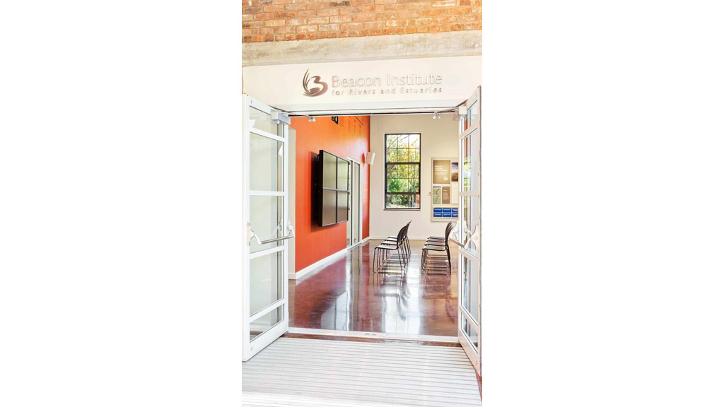 A hallway with a glass door.