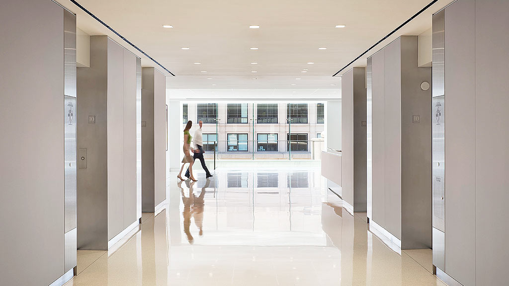 A couple of women walking in a hallway.