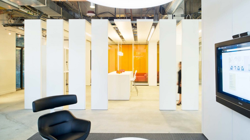 A room with a tv and chairs.