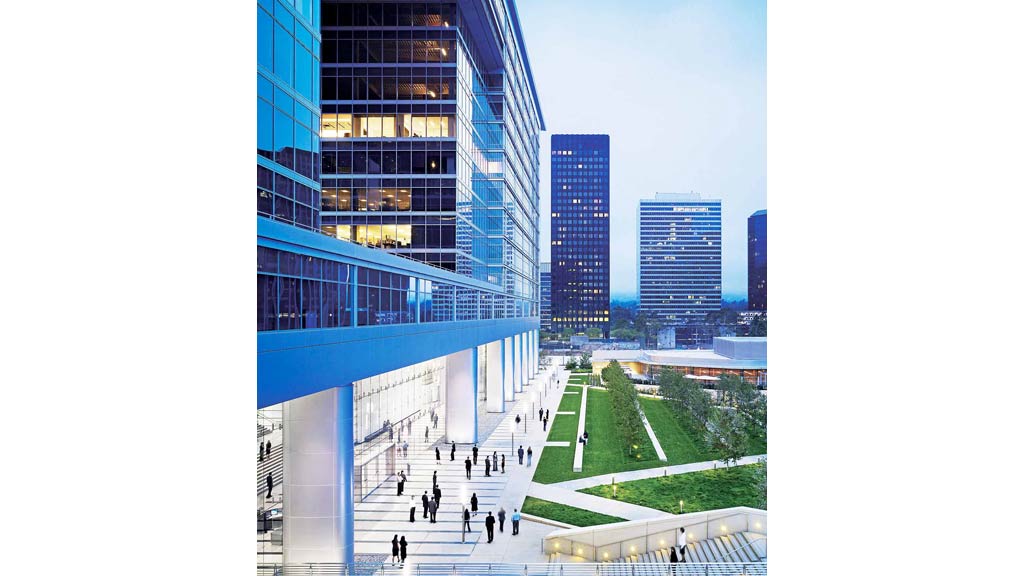 A group of people walking around a building.