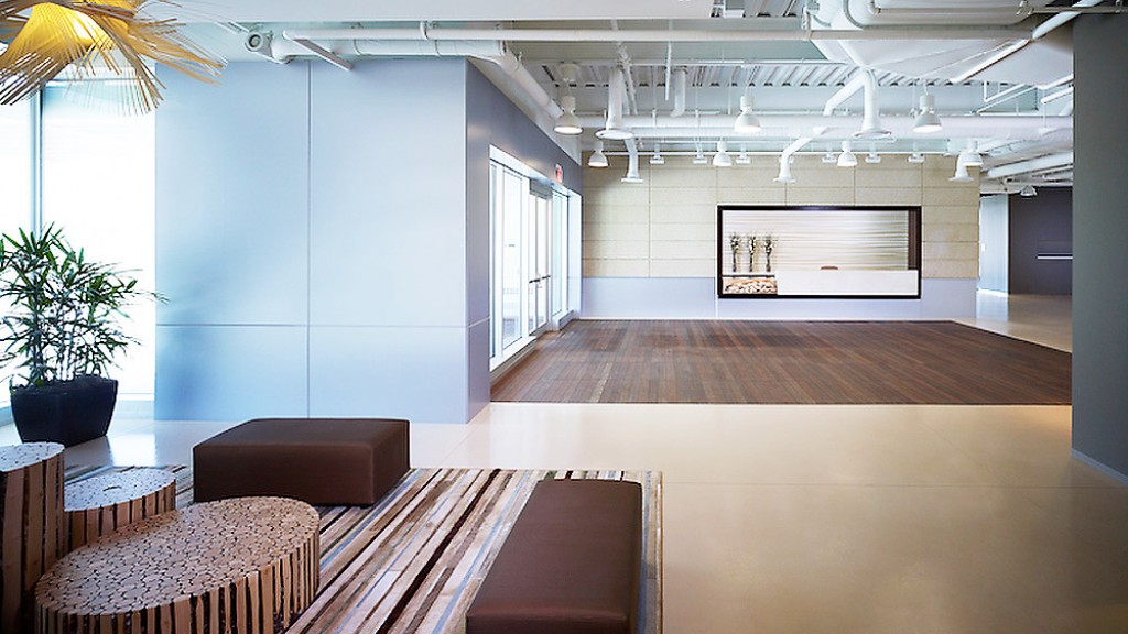 A room with a wood floor and chairs.