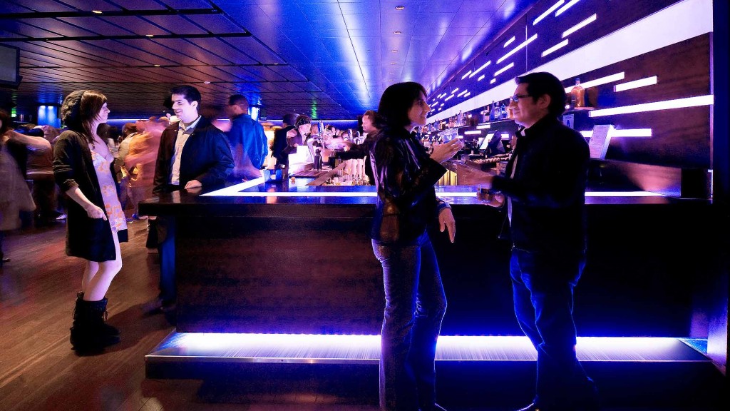 A group of people standing around a table.